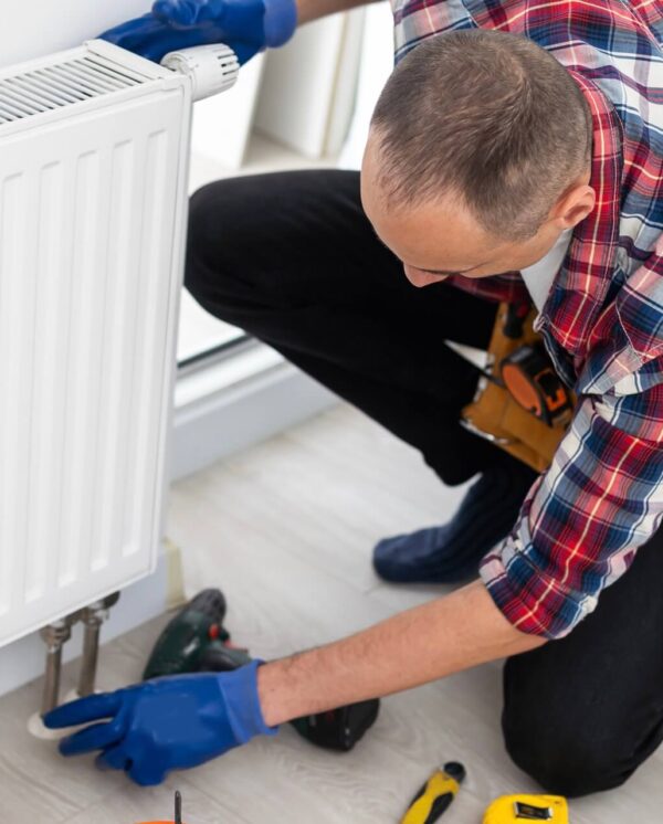 plumber-at-work-installing-water-heating-radiator-2024-02-01-12-30-07-utc plumber-at-work-installing-water-heating-radiator-2024-02-01-12-30-07-utc